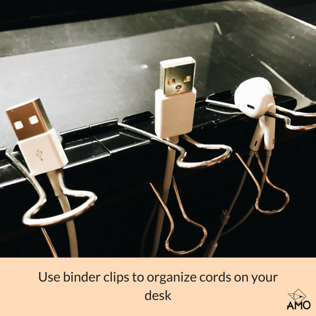 Image of binder clips to organize cords on a desk